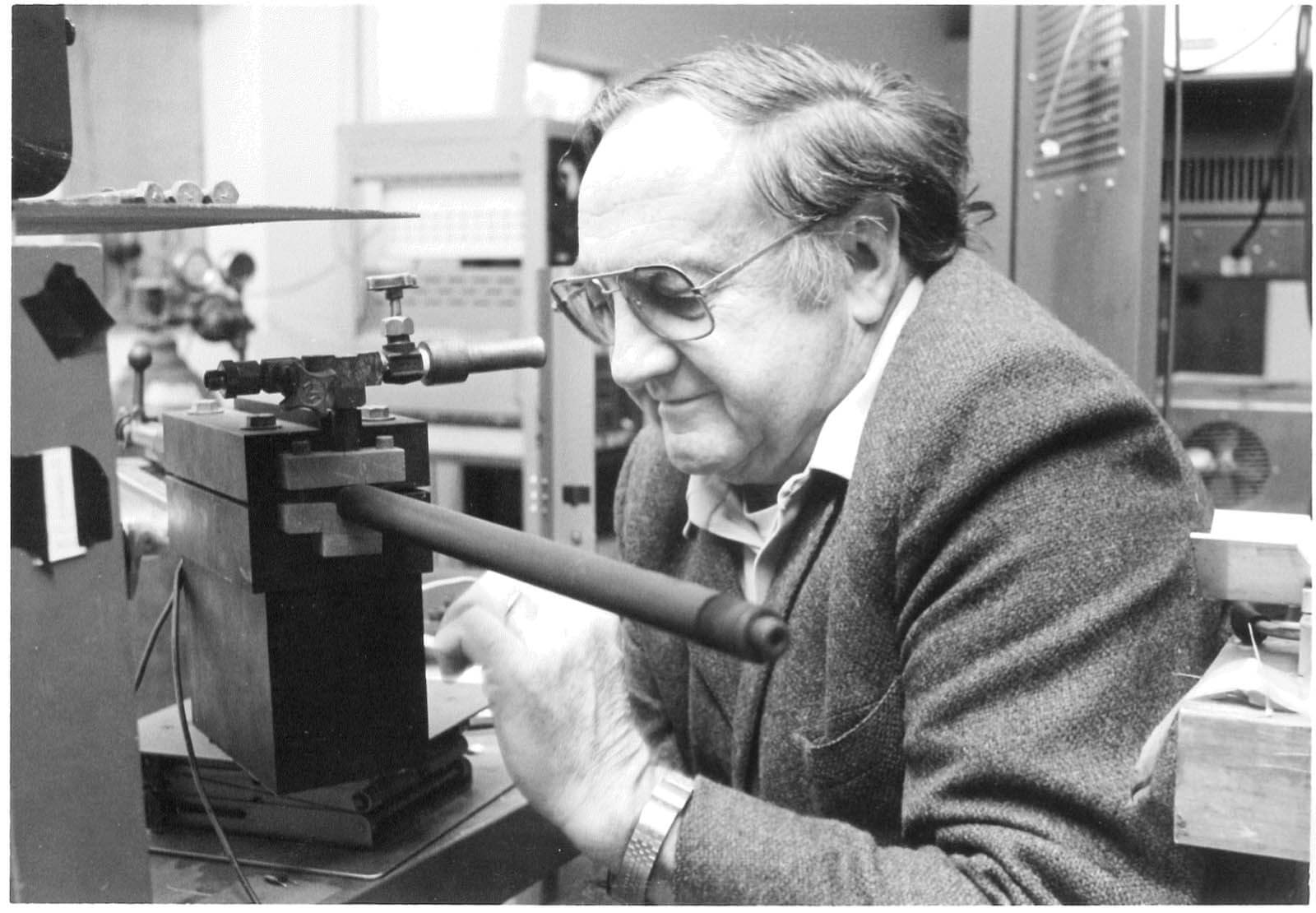 A vintage photo of a researcher works with a piece of equipment